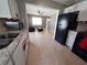 Open concept kitchen with white cabinets and black appliances, seamlessly connecting to the living area at 13 Euclid Dr, Plant City, FL 33563
