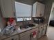 Kitchen has stainless steel sink, faucet, microwave and granite countertops at 13 Euclid Dr, Plant City, FL 33563