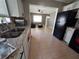 Open concept kitchen with white cabinets and black appliances, seamlessly connecting to the living area at 13 Euclid Dr, Plant City, FL 33563