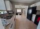 Open concept kitchen with white cabinets and black appliances, seamlessly connecting to the living area at 13 Euclid Dr, Plant City, FL 33563