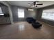 Inviting living room with a comfortable armchair, ottoman, and neutral color palette at 13 Euclid Dr, Plant City, FL 33563