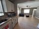 Open floor plan shows kitchen leading to living room with tile floors and ceiling fan at 13 Euclid Dr, Plant City, FL 33563