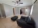 Stylish living room featuring a comfy leather chair and ottoman, with tile flooring and modern ceiling fan at 13 Euclid Dr, Plant City, FL 33563