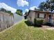 A side yard with a well-maintained lawn and tall metal fencing for privacy at 13 Euclid Dr, Plant City, FL 33563