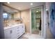 Bright bathroom features double vanity, a large mirror, marble floors, and a glass-enclosed shower at 4203 Fairway Run, Tampa, FL 33618
