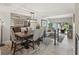 Elegant dining area with a modern chandelier, comfortable seating, and a view to the outdoor living space at 4203 Fairway Run, Tampa, FL 33618