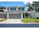 Inviting two-story home with a spacious driveway and lush green lawn on a sunny day at 4203 Fairway Run, Tampa, FL 33618