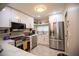 Modern kitchen with stainless steel appliances, white cabinets, and marble countertops at 4203 Fairway Run, Tampa, FL 33618