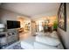 Living room view of open floor plan, decorative rug, and flows into adjacent dining and kitchen areas at 4203 Fairway Run, Tampa, FL 33618