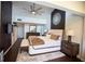Main bedroom with ceiling fan, a decorative mirror, and dark wood floors at 4203 Fairway Run, Tampa, FL 33618