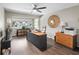 The cozy office space has hardwood floors, a ceiling fan, large window, and a large desk with executive chair at 4203 Fairway Run, Tampa, FL 33618