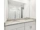 Bathroom featuring a double sink vanity with granite countertops and a glass enclosed shower at 1844 Brekey Way, Zephyrhills, FL 33541