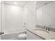Modern bathroom showcasing a granite countertop, white cabinetry, and a shower over tub at 1844 Brekey Way, Zephyrhills, FL 33541
