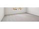 Bright bedroom featuring plush gray carpeting, neutral walls, and natural light from the windows at 1844 Brekey Way, Zephyrhills, FL 33541