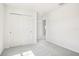 Neutral bedroom featuring plush gray carpeting, neutral walls, and a closet at 1844 Brekey Way, Zephyrhills, FL 33541
