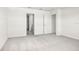 Well-lit bedroom featuring plush carpeting, ample natural light, and a walk-in closet at 1844 Brekey Way, Zephyrhills, FL 33541