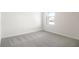 Cozy bedroom with neutral walls and plush carpeting, creating a comfortable and serene environment at 1844 Brekey Way, Zephyrhills, FL 33541
