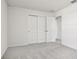 Bedroom with plush carpeting, white walls, and closet doors at 1844 Brekey Way, Zephyrhills, FL 33541