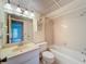 Well-lit bathroom features a shower-tub combo, ample lighting, and tiled walls at 1200 Tarpon Woods Blvd # L4, Palm Harbor, FL 34685