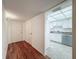 View of the unit's entry with wood floors leading to a bright kitchen at 1200 Tarpon Woods Blvd # L4, Palm Harbor, FL 34685