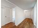 Bright hallway features hardwood floors and white walls offering a clean, modern aesthetic at 1200 Tarpon Woods Blvd # L4, Palm Harbor, FL 34685