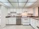 Bright kitchen features updated appliances and neutral countertops at 1200 Tarpon Woods Blvd # L4, Palm Harbor, FL 34685