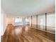 Open-concept living area with hardwood floors, mirrored wall, and seamless access to the kitchen at 1200 Tarpon Woods Blvd # L4, Palm Harbor, FL 34685