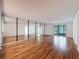 Bright and airy living room with hardwood floors and sliding glass doors to the balcony at 1200 Tarpon Woods Blvd # L4, Palm Harbor, FL 34685