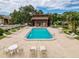 Community pool features plenty of lounging area, a jacuzzi, and a community building at 1200 Tarpon Woods Blvd # L4, Palm Harbor, FL 34685