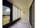 Cozy sunroom with access to the outdoors, featuring a decorative nautical wall anchor at 1200 Tarpon Woods Blvd # L4, Palm Harbor, FL 34685