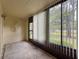 Enclosed sunroom with large windows offering a view of the outdoors at 1200 Tarpon Woods Blvd # L4, Palm Harbor, FL 34685