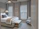 Cozy bedroom with a plush bed, side tables, neutral decor, and plenty of natural light from large windows at 2729 Gabel Oak Dr, North Port, FL 34289