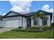 Charming one-story home featuring a well-manicured lawn, elegant landscaping, and a two-car garage at 2729 Gabel Oak Dr, North Port, FL 34289