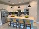 Bright, modern kitchen with stainless steel appliances, quartz countertops, and a center island with seating at 2729 Gabel Oak Dr, North Port, FL 34289