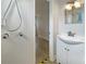 The bathroom shows a shower with tile surround and a vanity with sink at 5629 Nutmeg Ave, Sarasota, FL 34231