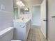 This bathroom features a vanity with a sink, a mirror, and tiled walls at 5629 Nutmeg Ave, Sarasota, FL 34231