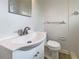 This bathroom is equipped with a vanity with sink, a mirror, and a toilet at 5629 Nutmeg Ave, Sarasota, FL 34231