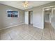 Minimalist bedroom with neutral walls, tiled flooring, and a closet for storage at 5629 Nutmeg Ave, Sarasota, FL 34231