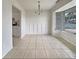 Bright dining area with decorative wainscoting, tiled floor, and natural light from large windows at 5629 Nutmeg Ave, Sarasota, FL 34231