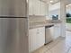 Modern kitchen featuring stainless steel appliances, white cabinets, and granite countertops at 5629 Nutmeg Ave, Sarasota, FL 34231