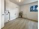 The laundry room includes a water heater, updated flooring, and bright natural light from the window at 5629 Nutmeg Ave, Sarasota, FL 34231
