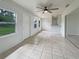 The sunroom offers tiled floors, a ceiling fan, and access to the outside and kitchen at 5629 Nutmeg Ave, Sarasota, FL 34231