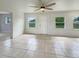The sunroom features tiled flooring, lots of windows, and a ceiling fan at 5629 Nutmeg Ave, Sarasota, FL 34231