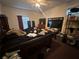 A bedroom featuring a ceiling fan, windows, and a variety of furniture, including a bed and television at 1009 S Clark Ave, Tampa, FL 33629
