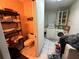 A combined laundry and small bathroom area with shelving and a toilet adjacent to the washer and dryer at 1009 S Clark Ave, Tampa, FL 33629