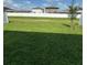 Spacious grassy backyard enclosed by a tall white fence, perfect for outdoor activities at 13707 Newbridge St, Spring Hill, FL 34609