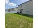 A cozy backyard with a white privacy fence, green grass, and a small seating area at 13707 Newbridge St, Spring Hill, FL 34609
