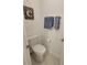 Small bathroom features a toilet, vanity, and a towel rack, providing essential functionality in a compact space at 13707 Newbridge St, Spring Hill, FL 34609