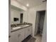 A bathroom with a double sink vanity and view of the shower at 13707 Newbridge St, Spring Hill, FL 34609