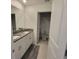 A bathroom with a double sink vanity and a view into the shower at 13707 Newbridge St, Spring Hill, FL 34609